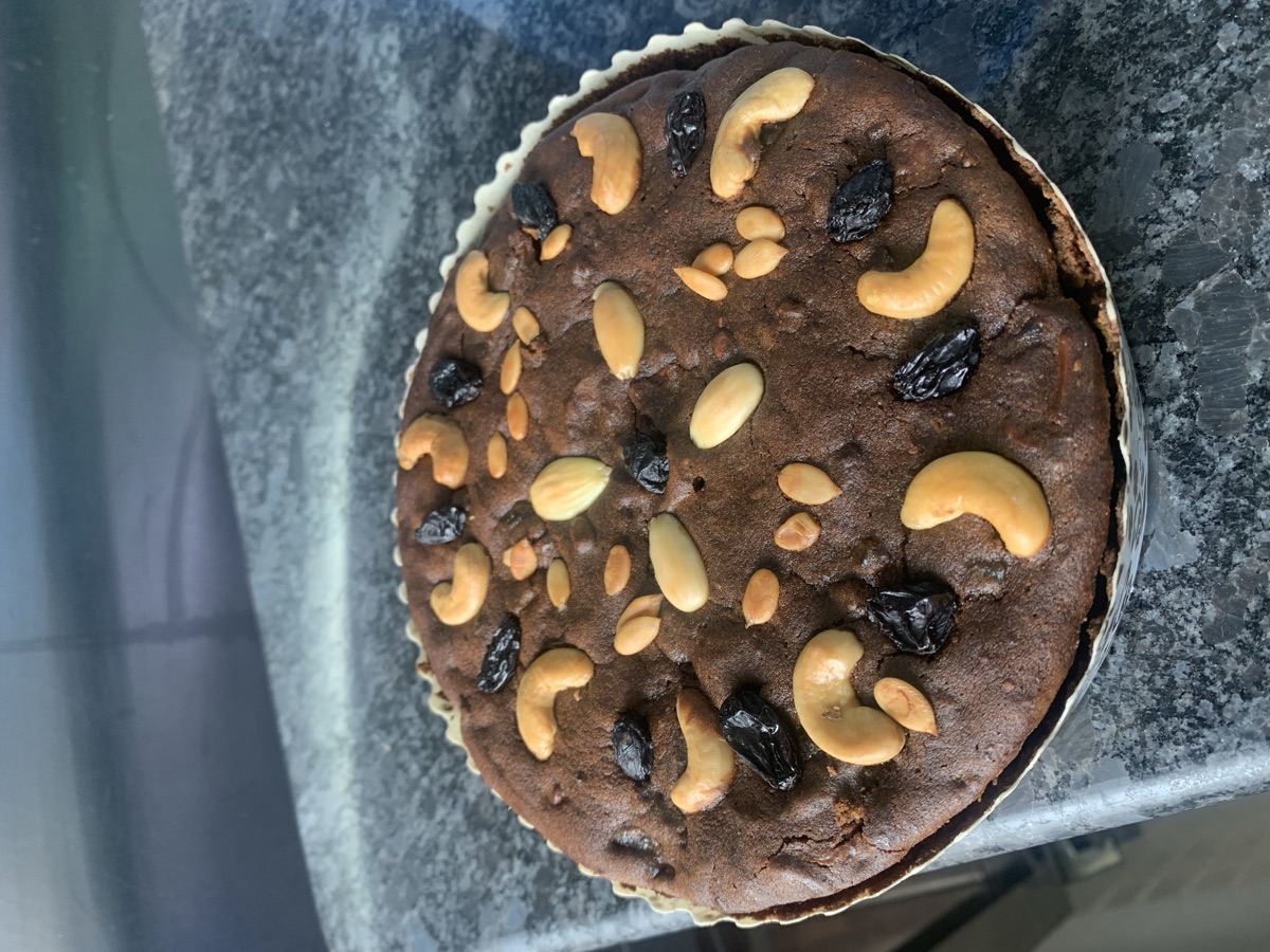 Rich fruit-and-nut plum cake topped with cashews and raisins